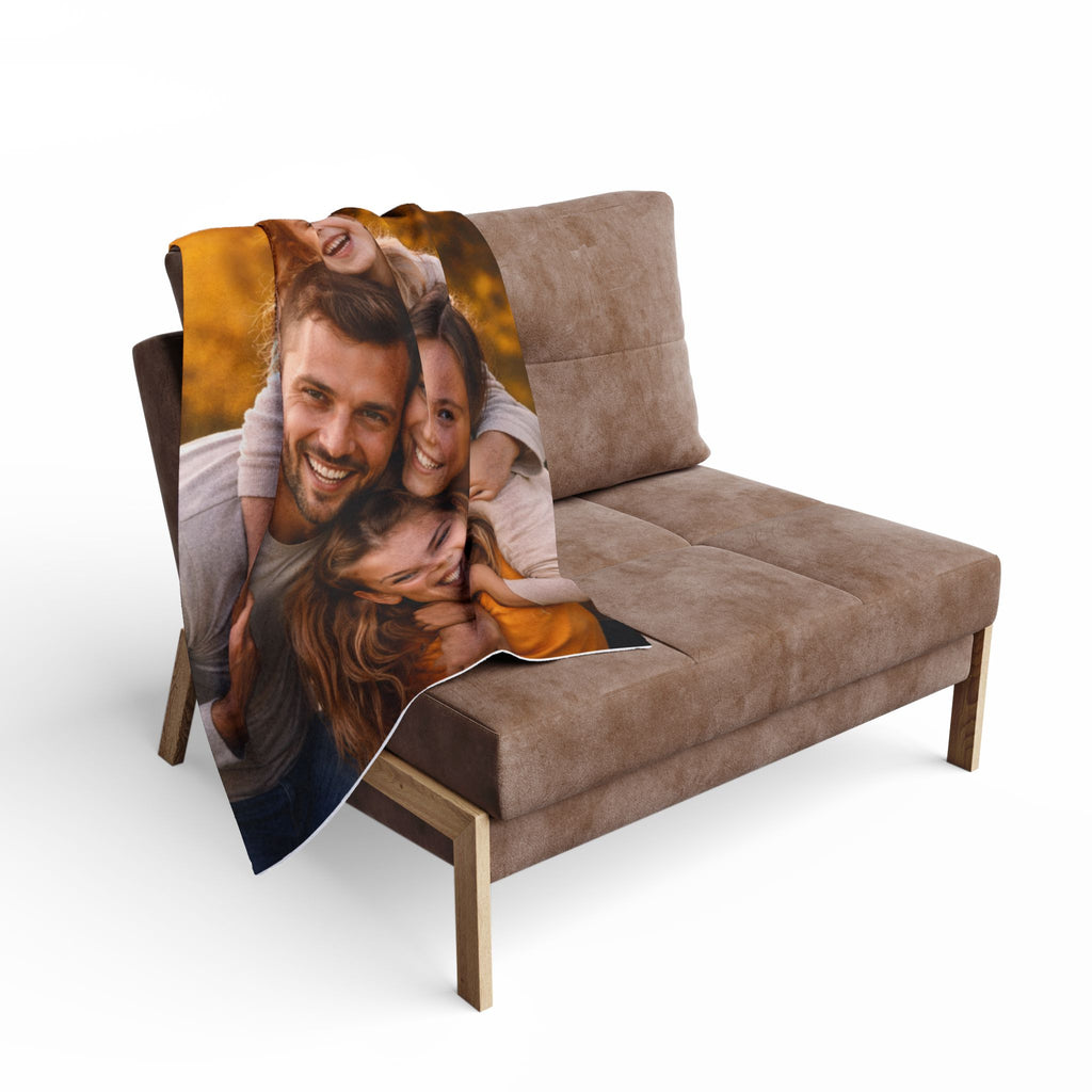 Brown sofa with a photo blanket featuring a family on a white background